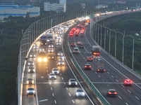 Traffic flows for several kilometers past the G15 Shenyang-Haikou Expressway of the Sutong Yangtze River Bridge in Changshu, China, on Septe...