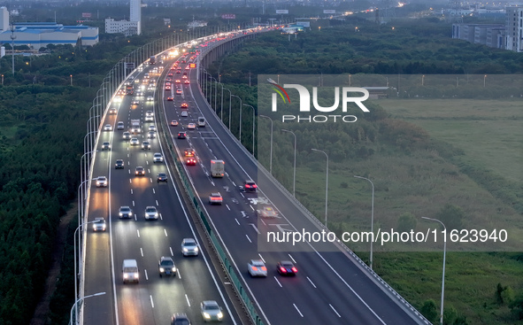 Traffic flows for several kilometers past the G15 Shenyang-Haikou Expressway of the Sutong Yangtze River Bridge in Changshu, China, on Septe...