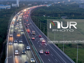 Traffic flows for several kilometers past the G15 Shenyang-Haikou Expressway of the Sutong Yangtze River Bridge in Changshu, China, on Septe...