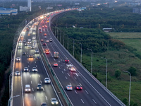 Traffic flows for several kilometers past the G15 Shenyang-Haikou Expressway of the Sutong Yangtze River Bridge in Changshu, China, on Septe...