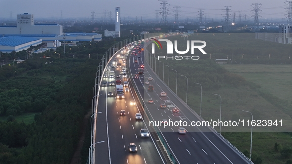 Traffic flows for several kilometers past the G15 Shenyang-Haikou Expressway of the Sutong Yangtze River Bridge in Changshu, China, on Septe...