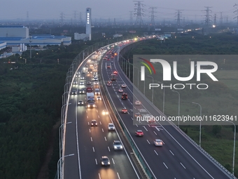 Traffic flows for several kilometers past the G15 Shenyang-Haikou Expressway of the Sutong Yangtze River Bridge in Changshu, China, on Septe...