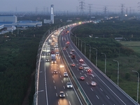 Traffic flows for several kilometers past the G15 Shenyang-Haikou Expressway of the Sutong Yangtze River Bridge in Changshu, China, on Septe...