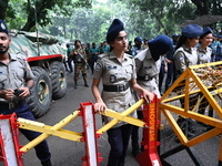 Bangladeshi police stand guard in front of the chief adviser's residence, Jamuna, as job seekers stage a demonstration on the road demanding...