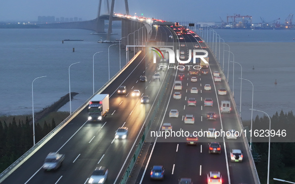 Traffic flows for several kilometers past the G15 Shenyang-Haikou Expressway of the Sutong Yangtze River Bridge in Changshu, China, on Septe...