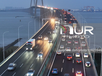 Traffic flows for several kilometers past the G15 Shenyang-Haikou Expressway of the Sutong Yangtze River Bridge in Changshu, China, on Septe...