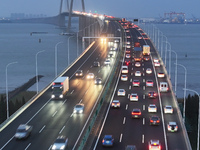 Traffic flows for several kilometers past the G15 Shenyang-Haikou Expressway of the Sutong Yangtze River Bridge in Changshu, China, on Septe...