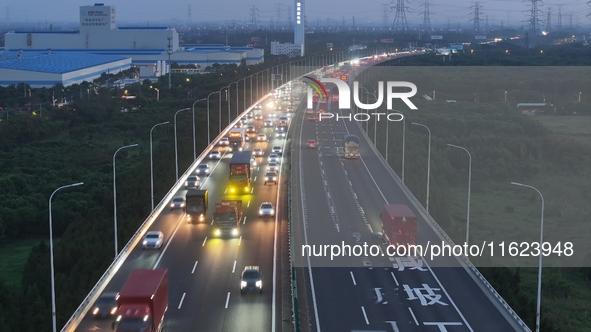 Traffic flows for several kilometers past the G15 Shenyang-Haikou Expressway of the Sutong Yangtze River Bridge in Changshu, China, on Septe...