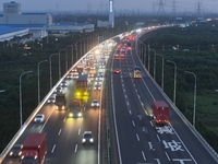 Traffic flows for several kilometers past the G15 Shenyang-Haikou Expressway of the Sutong Yangtze River Bridge in Changshu, China, on Septe...