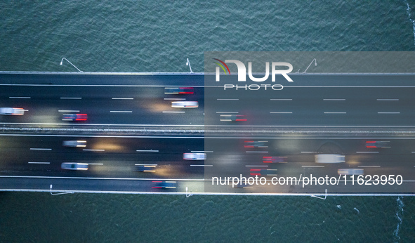 Traffic flows for several kilometers past the G15 Shenyang-Haikou Expressway of the Sutong Yangtze River Bridge in Changshu, China, on Septe...