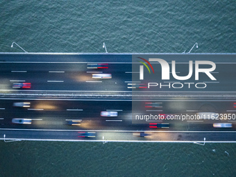 Traffic flows for several kilometers past the G15 Shenyang-Haikou Expressway of the Sutong Yangtze River Bridge in Changshu, China, on Septe...