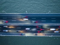 Traffic flows for several kilometers past the G15 Shenyang-Haikou Expressway of the Sutong Yangtze River Bridge in Changshu, China, on Septe...