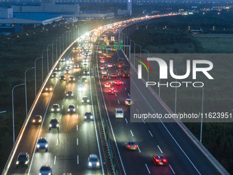 Traffic flows for several kilometers past the G15 Shenyang-Haikou Expressway of the Sutong Yangtze River Bridge in Changshu, China, on Septe...