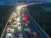 Traffic flows for several kilometers past the G15 Shenyang-Haikou Expressway of the Sutong Yangtze River Bridge in Changshu, China, on Septe...