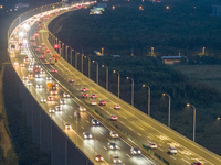 Traffic flows for several kilometers past the G15 Shenyang-Haikou Expressway of the Sutong Yangtze River Bridge in Changshu, China, on Septe...