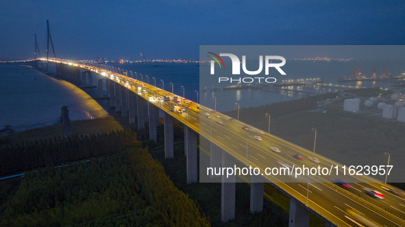 Traffic flows for several kilometers past the G15 Shenyang-Haikou Expressway of the Sutong Yangtze River Bridge in Changshu, China, on Septe...