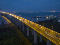 Traffic flows for several kilometers past the G15 Shenyang-Haikou Expressway of the Sutong Yangtze River Bridge in Changshu, China, on Septe...