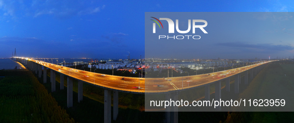 Traffic flows for several kilometers past the G15 Shenyang-Haikou Expressway of the Sutong Yangtze River Bridge in Changshu, China, on Septe...