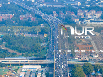 A photo taken in Nanjing, China, on September 30, 2024, shows the traffic flow on the elevated road in the south of Nanjing City, Jiangsu Pr...