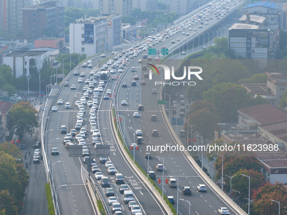 A photo taken in Nanjing, China, on September 30, 2024, shows the traffic flow on the elevated road in the south of Nanjing City, Jiangsu Pr...