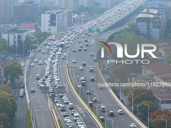 A photo taken in Nanjing, China, on September 30, 2024, shows the traffic flow on the elevated road in the south of Nanjing City, Jiangsu Pr...