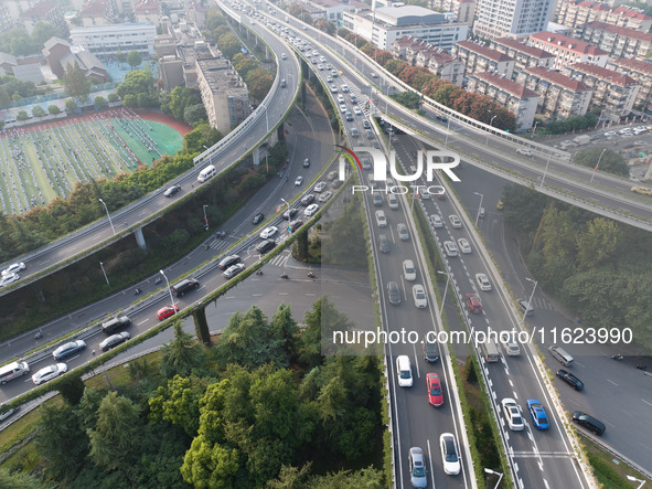 A photo taken in Nanjing, China, on September 30, 2024, shows the traffic flow on the elevated road in the south of Nanjing City, Jiangsu Pr...