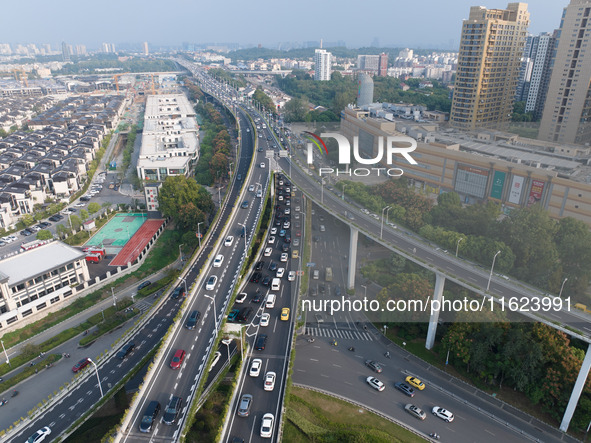 A photo taken in Nanjing, China, on September 30, 2024, shows the traffic flow on the elevated road in the south of Nanjing City, Jiangsu Pr...