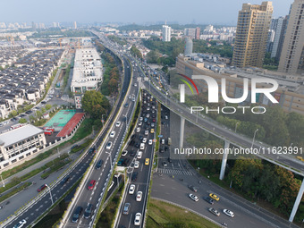 A photo taken in Nanjing, China, on September 30, 2024, shows the traffic flow on the elevated road in the south of Nanjing City, Jiangsu Pr...