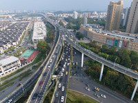 A photo taken in Nanjing, China, on September 30, 2024, shows the traffic flow on the elevated road in the south of Nanjing City, Jiangsu Pr...