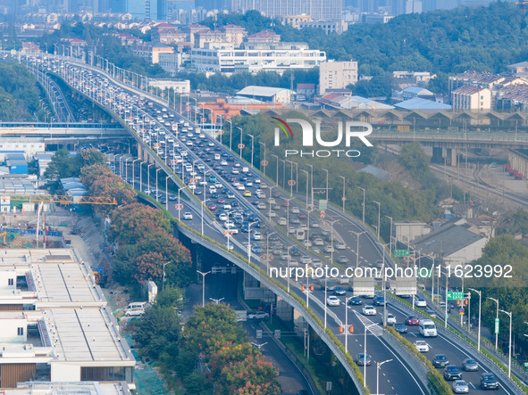 A photo taken in Nanjing, China, on September 30, 2024, shows the traffic flow on the elevated road in the south of Nanjing City, Jiangsu Pr...