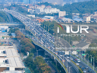 A photo taken in Nanjing, China, on September 30, 2024, shows the traffic flow on the elevated road in the south of Nanjing City, Jiangsu Pr...