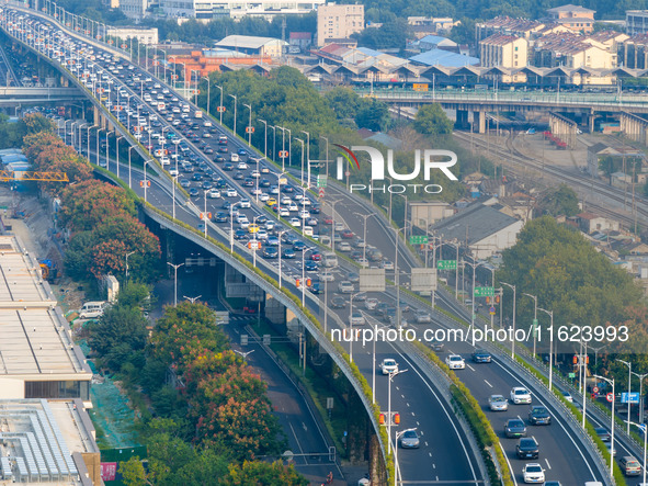 A photo taken in Nanjing, China, on September 30, 2024, shows the traffic flow on the elevated road in the south of Nanjing City, Jiangsu Pr...