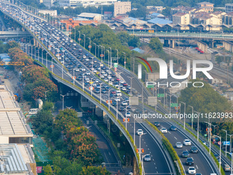 A photo taken in Nanjing, China, on September 30, 2024, shows the traffic flow on the elevated road in the south of Nanjing City, Jiangsu Pr...