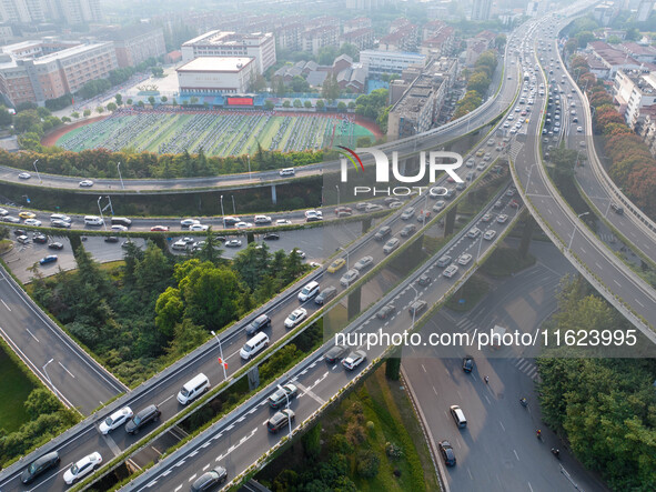 A photo taken in Nanjing, China, on September 30, 2024, shows the traffic flow on the elevated road in the south of Nanjing City, Jiangsu Pr...