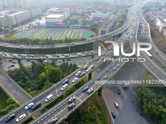 A photo taken in Nanjing, China, on September 30, 2024, shows the traffic flow on the elevated road in the south of Nanjing City, Jiangsu Pr...