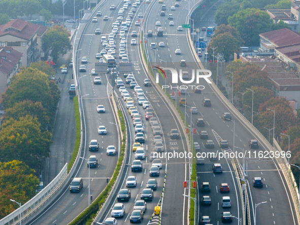 A photo taken in Nanjing, China, on September 30, 2024, shows the traffic flow on the elevated road in the south of Nanjing City, Jiangsu Pr...