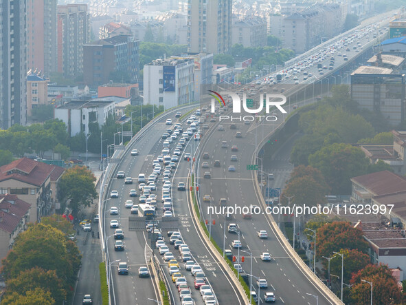 A photo taken in Nanjing, China, on September 30, 2024, shows the traffic flow on the elevated road in the south of Nanjing City, Jiangsu Pr...