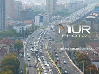 A photo taken in Nanjing, China, on September 30, 2024, shows the traffic flow on the elevated road in the south of Nanjing City, Jiangsu Pr...