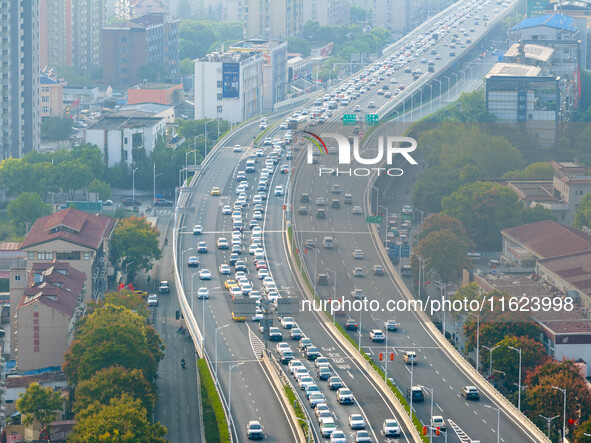 A photo taken in Nanjing, China, on September 30, 2024, shows the traffic flow on the elevated road in the south of Nanjing City, Jiangsu Pr...