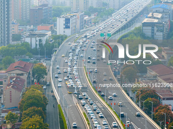 A photo taken in Nanjing, China, on September 30, 2024, shows the traffic flow on the elevated road in the south of Nanjing City, Jiangsu Pr...