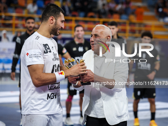 Hussen Labib, chairman of the board of directors of Zamalek, delivers the Man of the Match award to Mohamed Yehia Elderaa of Veszprem HC aft...