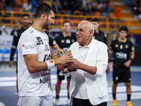 Hussen Labib, chairman of the board of directors of Zamalek, delivers the Man of the Match award to Mohamed Yehia Elderaa of Veszprem HC aft...