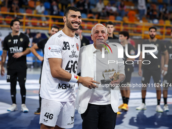 Hussen Labib, chairman of the board of directors of Zamalek, delivers the Man of the Match award to Mohamed Yehia Elderaa of Veszprem HC aft...