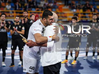 Hussen Labib, chairman of the board of directors of Zamalek, delivers the Man of the Match award to Mohamed Yehia Elderaa of Veszprem HC aft...