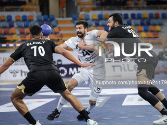 Agustin Casado Marcelo of Veszprem HC battles for the ball with Mohamed Abo Saleem of Zamalek Club during the IHF Men's Handball Club World...