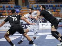 Agustin Casado Marcelo of Veszprem HC battles for the ball with Mohamed Abo Saleem of Zamalek Club during the IHF Men's Handball Club World...