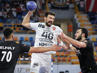 Agustin Casado Marcelo of Veszprem HC battles for the ball with Mohamed Abo Saleem of Zamalek Club during the IHF Men's Handball Club World...