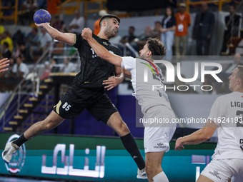 Nedim Remili of Veszprem HC battles for the ball with Omar Sadek of Zamalek Club during the IHF Men's Handball Club World Championship 2024...