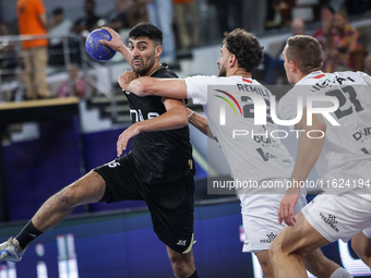 Nedim Remili of Veszprem HC battles for the ball with Omar Sadek of Zamalek Club during the IHF Men's Handball Club World Championship 2024...