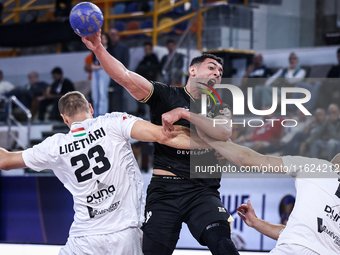 Jonathan Sandell Lukas Peter (17) and Patrik Ligetvari (23) of Veszprem HC battle for the ball with Ahmed Abdelhamid (29) of Zamalek Club du...